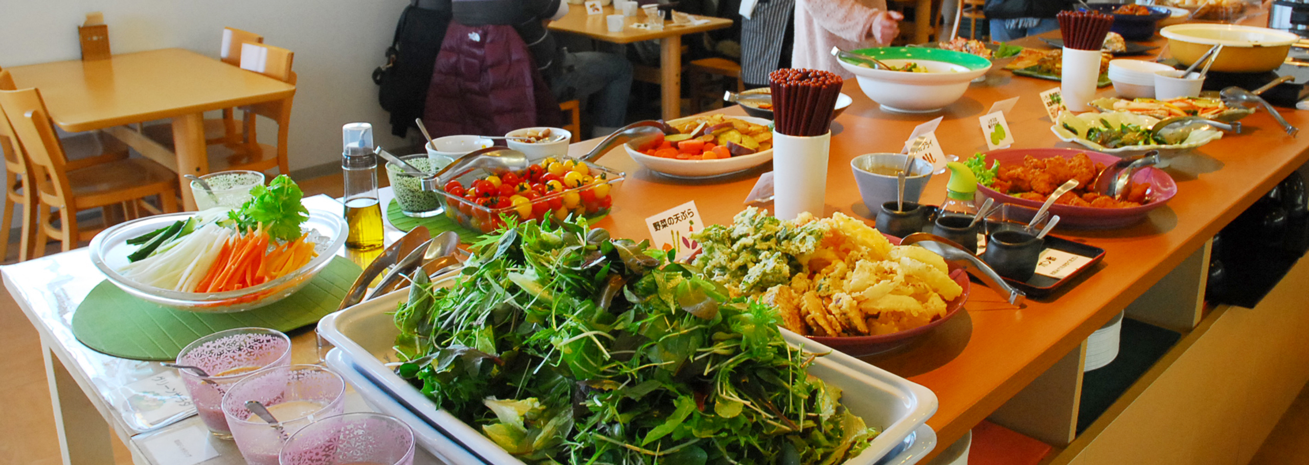 A buffet with fresh vegetables and local dishes