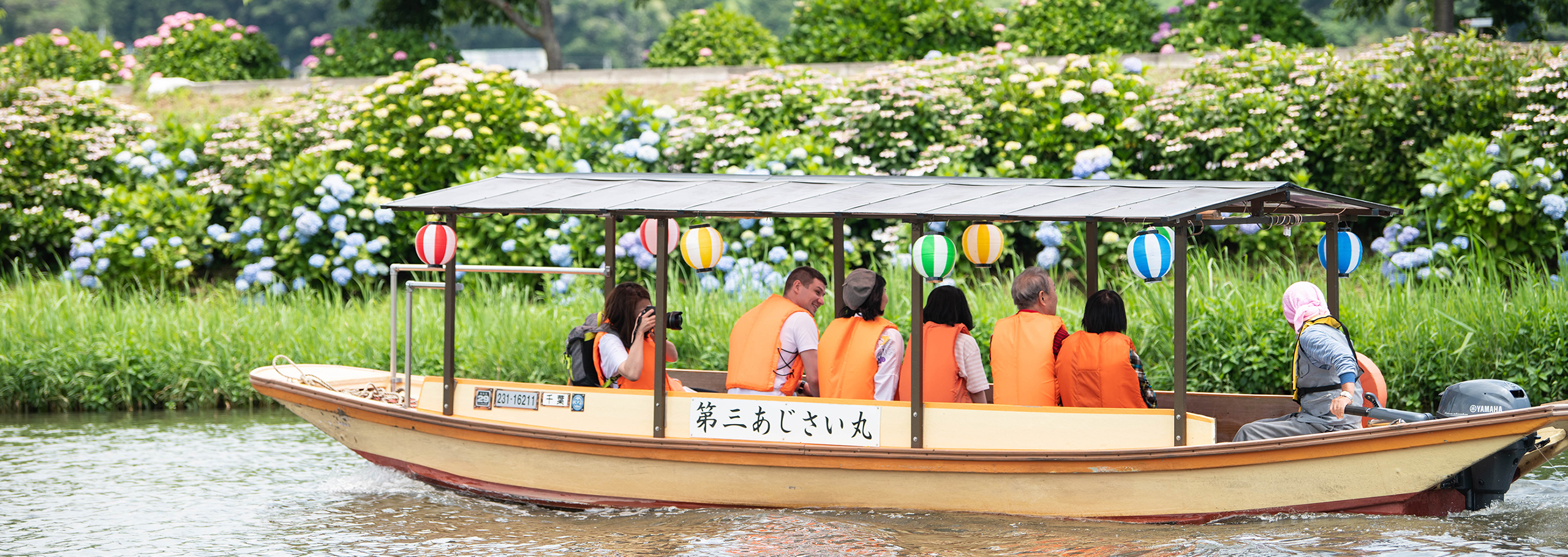 Visitors enjoying a boat ride along a river