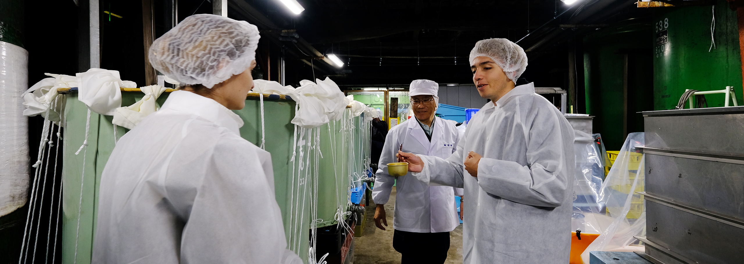 Visitors touring a sake brewery in Kozaki Town